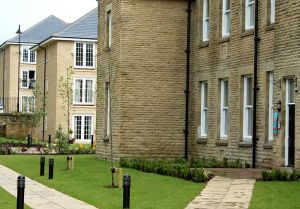 The former female chronic block converted to housing with the new build in the near distance.